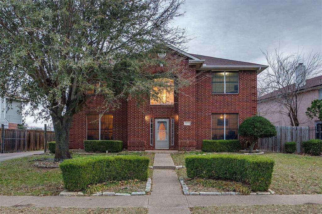 Traditional-style home featuring brick siding