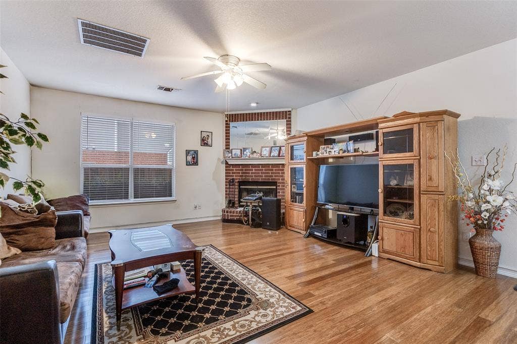 Living area featuring ceiling fan and light wood-style floors