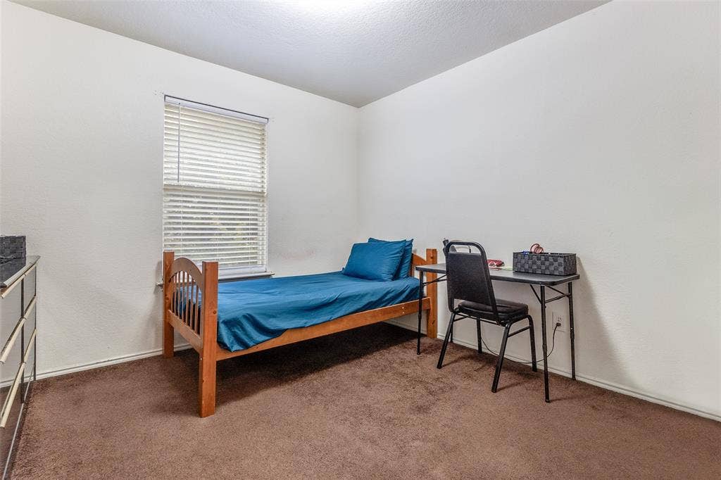 Carpeted bedroom with baseboards