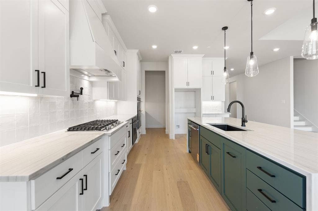 1571 Temple Court, Prosper, TX 75078 Beautiful cabinetry, gorgeous countertops and designer backsplash paired with contemporary stainless steel creates a chef's kitchen for the ages!
