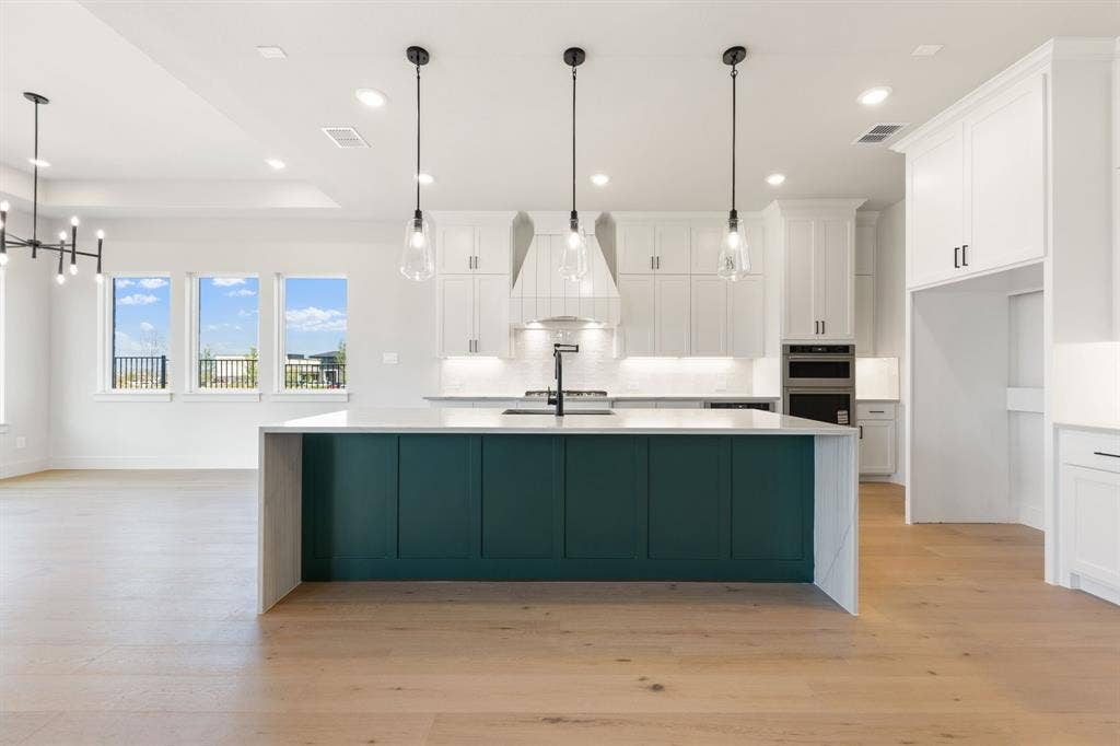 1571 Temple Court, Prosper, TX 75078 The oversized island is the perfect place for friends and family to gather round.