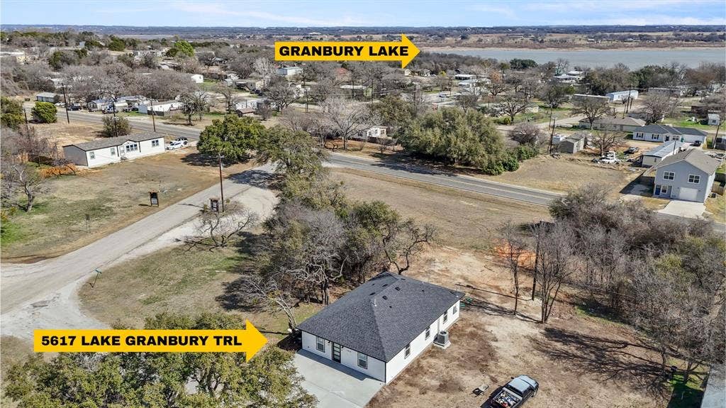 5619 Lake Granbury Trail, Granbury, TX 76048 Single-story residence featuring a dark shingle roof and light-toned siding