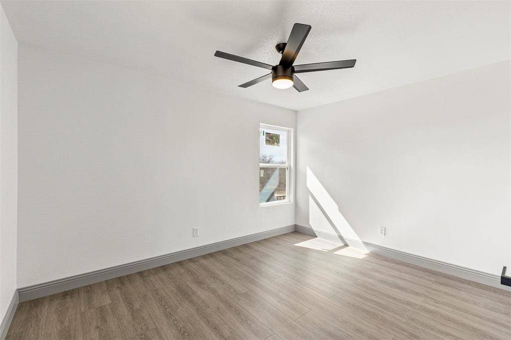 5619 Lake Granbury Trail, Granbury, TX 76048 Unfurnished room with light wood finished floors and a ceiling fan