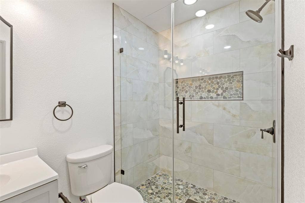 5619 Lake Granbury Trail, Granbury, TX 76048 Bathroom with vanity and a shower stall