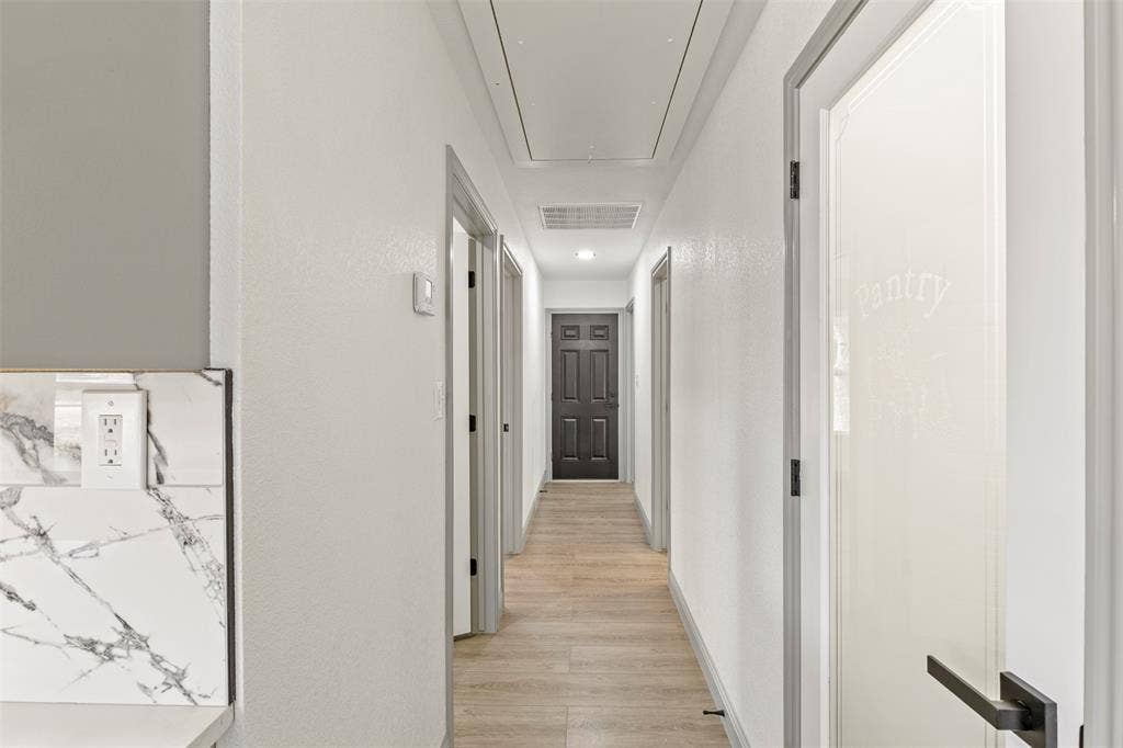 5619 Lake Granbury Trail, Granbury, TX 76048 Corridor with light wood-type flooring, a textured wall, and recessed lighting