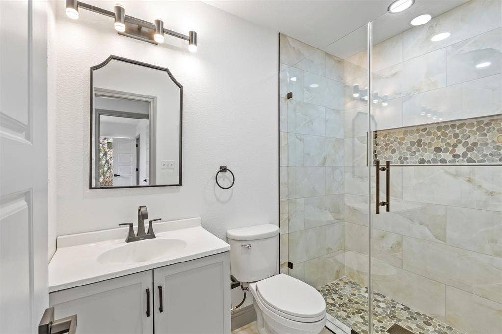5619 Lake Granbury Trail, Granbury, TX 76048 Bathroom with vanity and a stall shower