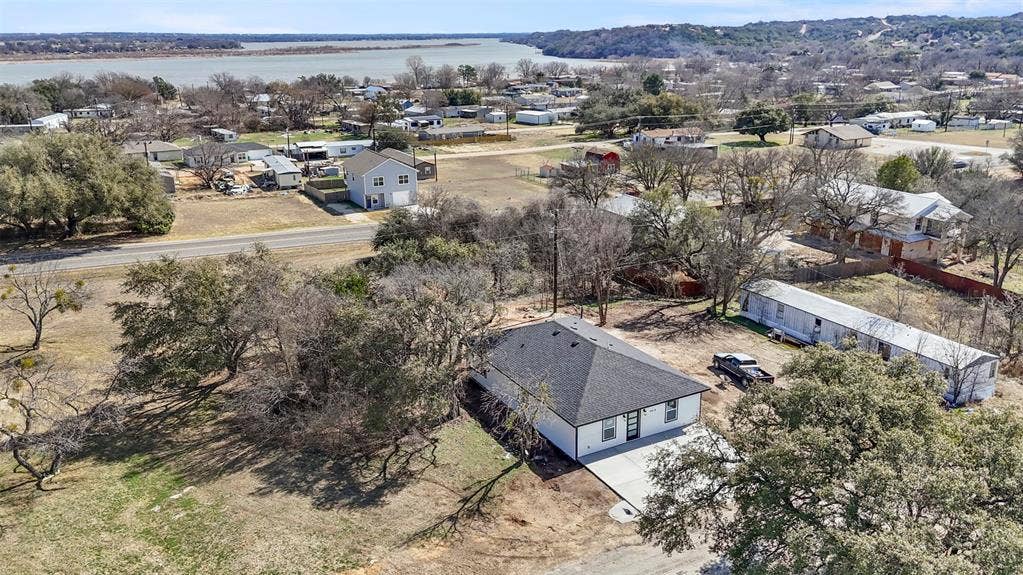 5619 Lake Granbury Trail, Granbury, TX 76048 Aerial perspective of suburban area with a nearby body of water