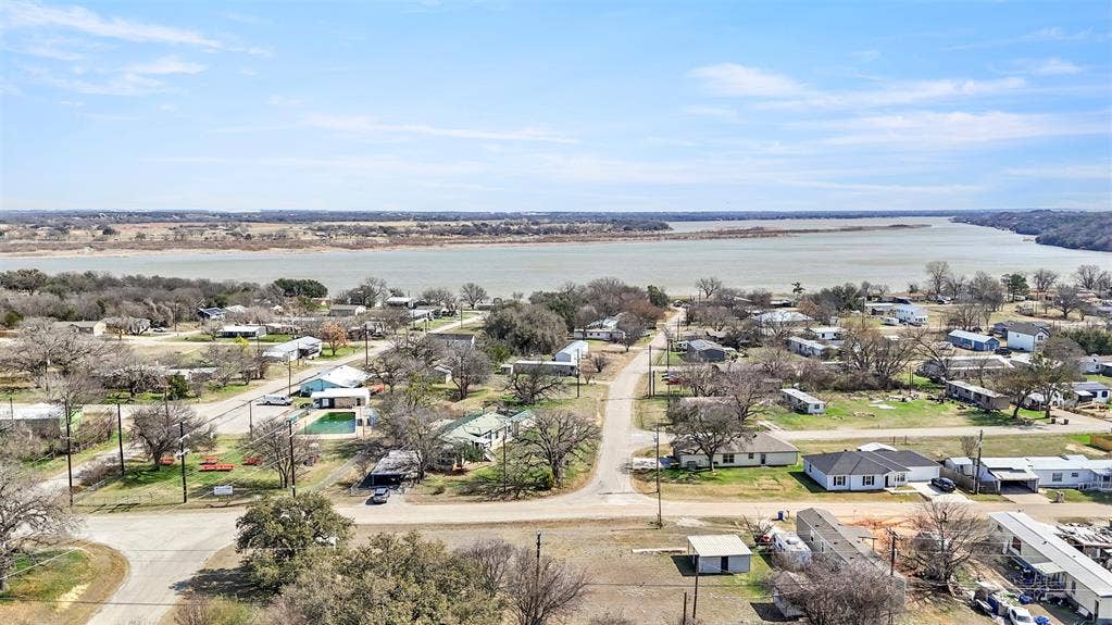 5619 Lake Granbury Trail, Granbury, TX 76048 Aerial perspective of suburban area featuring a large body of water