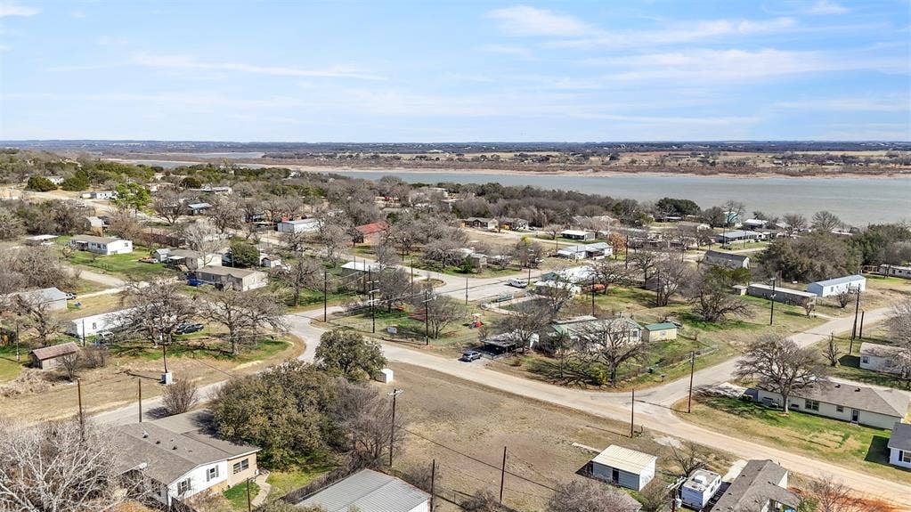 5619 Lake Granbury Trail, Granbury, TX 76048 Aerial perspective of suburban area featuring a large body of water