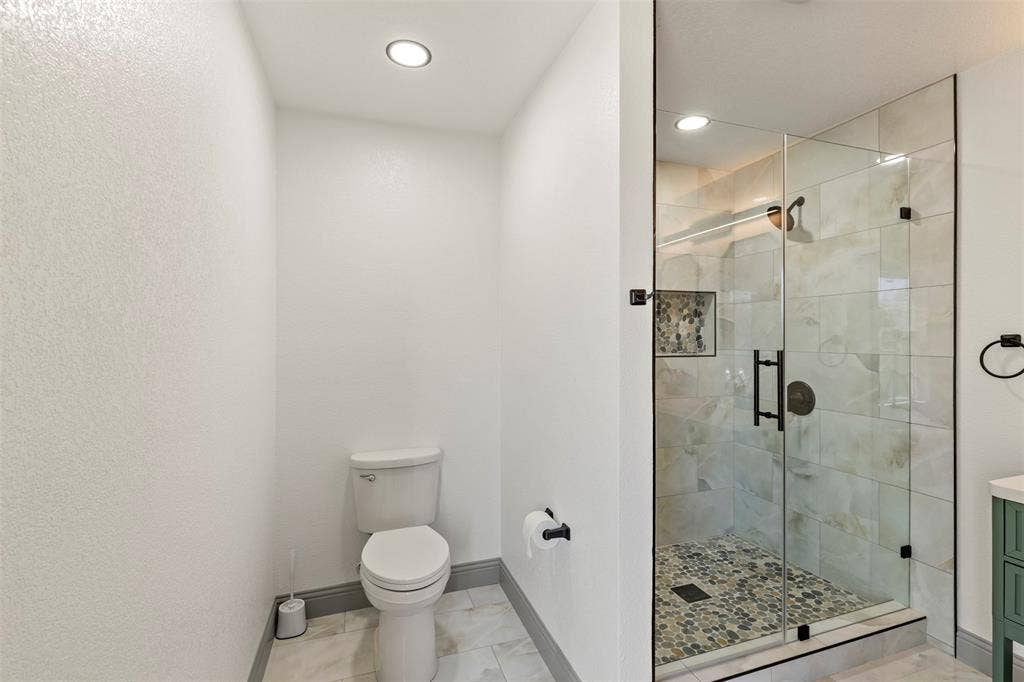 5619 Lake Granbury Trail, Granbury, TX 76048 Bathroom featuring a shower stall, vanity, and recessed lighting