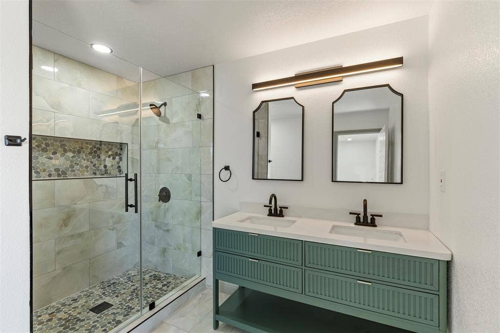 5619 Lake Granbury Trail, Granbury, TX 76048 Bathroom with double vanity, a shower stall, and recessed lighting