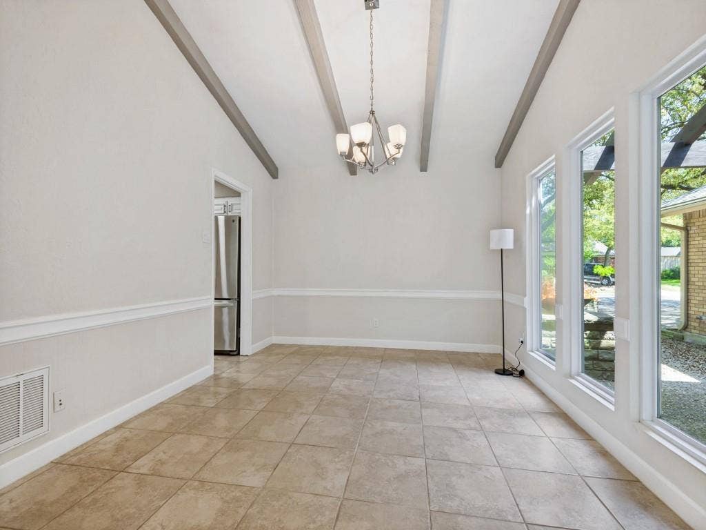 108 Wellesley Drive, Irving, TX 75062 Dining area with a chandelier, vaulted ceiling with beams, and light tile patterned floors