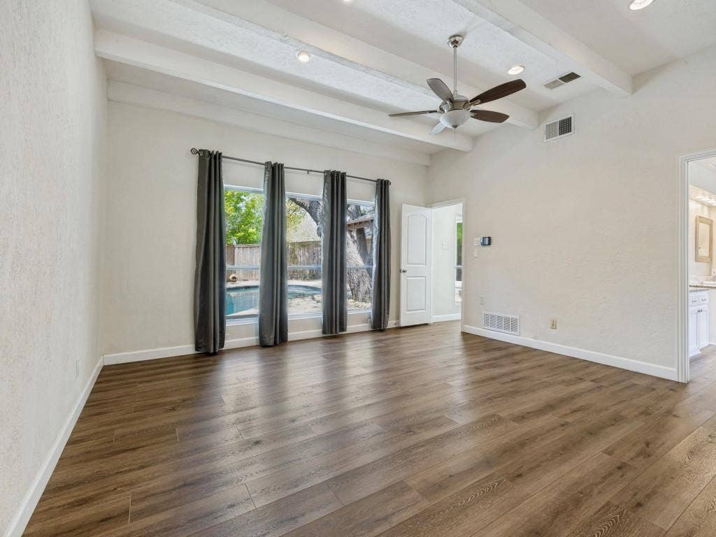 108 Wellesley Drive, Irving, TX 75062 Primary Bedroom room featuring a ceiling fan, dark wood-style flooring, recessed lighting, a textured wall, and beam ceiling