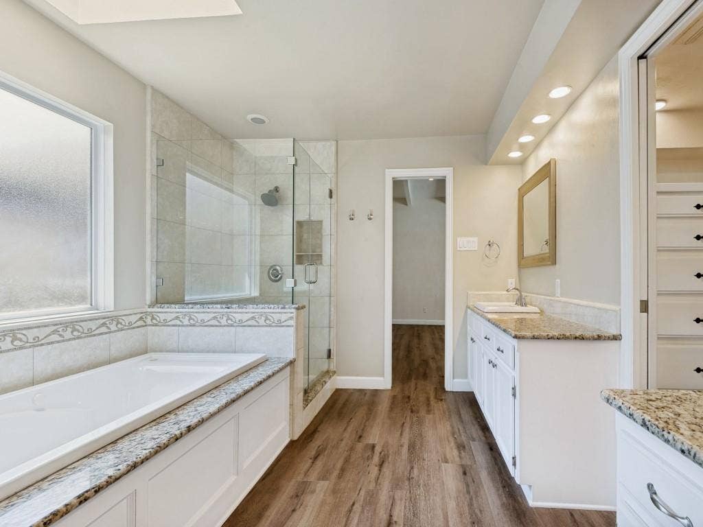 108 Wellesley Drive, Irving, TX 75062 Bathroom featuring vanity, a stall shower, a bath, dark wood finished floors, and recessed lighting