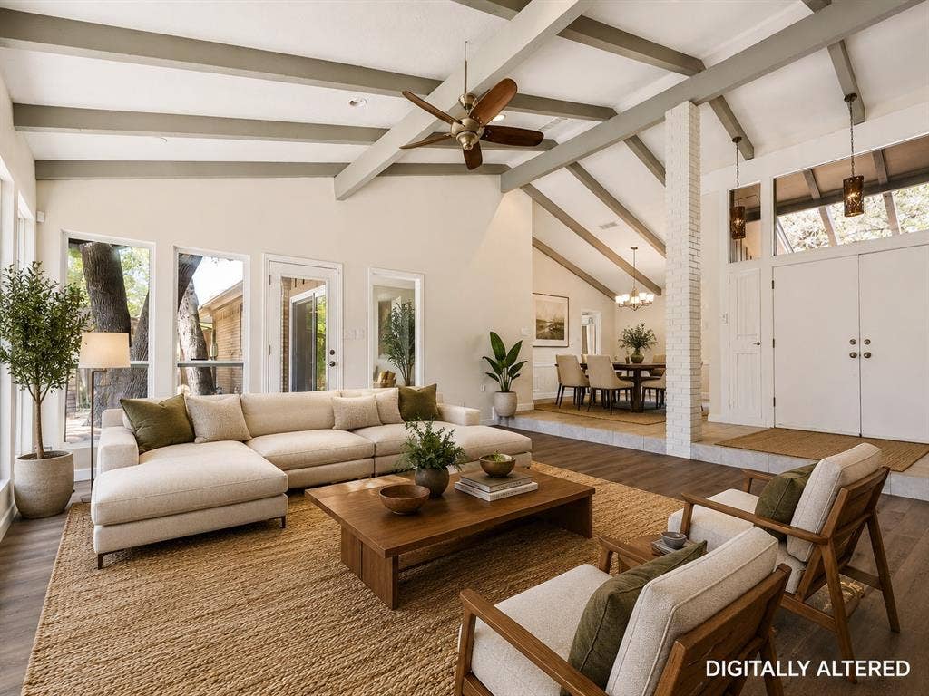 108 Wellesley Drive, Irving, TX 75062 Spacious living area featuring a vaulted ceiling with exposed beams, wood-finish flooring, and multiple large windows - Virtual Staging