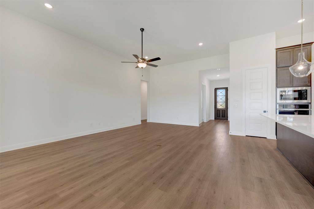 Open-concept living space with wood-finish flooring