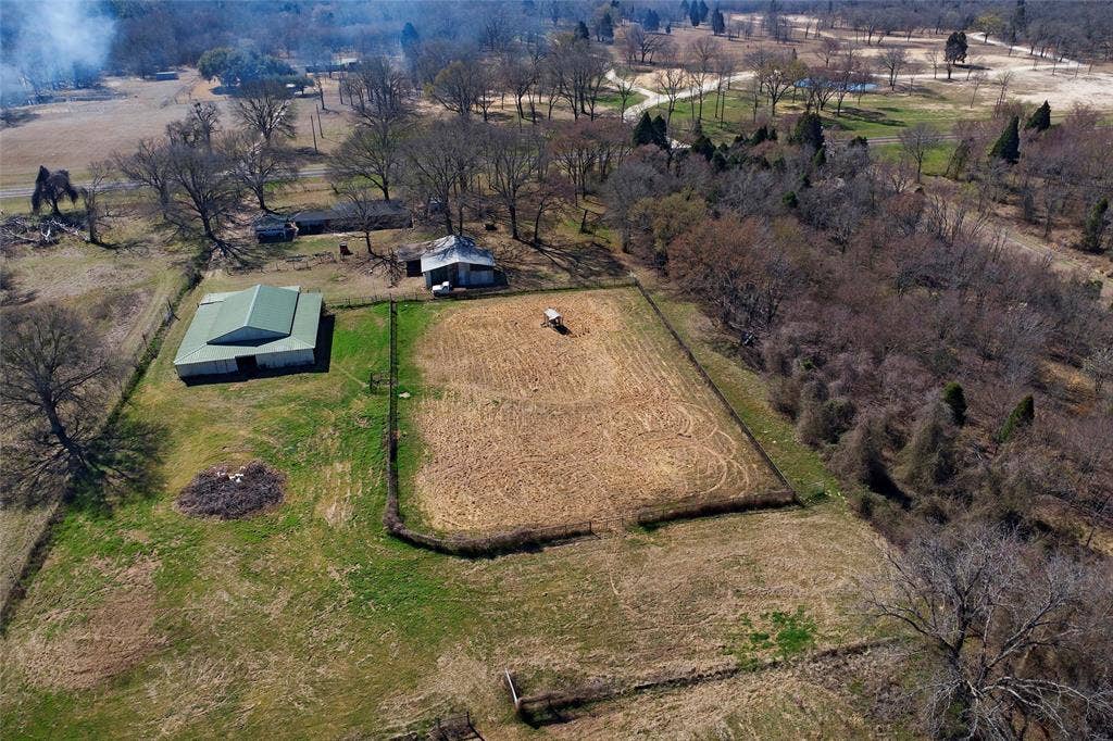 15314 Fm 3062, Malakoff, TX 75148 First pasture to home. Notice first pasture is fenced across with gate. Incl in first pasture is a one acre small animal yard. Large 4 stall horse barn on L Storage Bld with attached living quarters in middle.