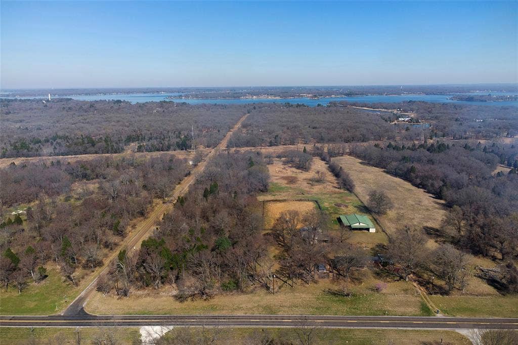 15314 Fm 3062, Malakoff, TX 75148 Front to Back That strip of heavily wooded acreage is the neighbor's, that fence line just to the right of the barn is the other neighbor, that stip of cleared land between the woods is a utility easement. The 9.8 acreas goes behond the utility easement and the back of the acreadge is heavily wooded