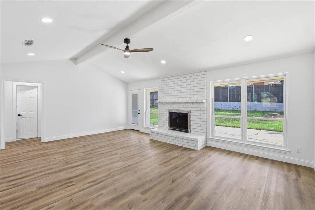 2211 Sierra Drive, Grapevine, TX 76051 Unfurnished living room featuring a ceiling fan, healthy amount of natural light, recessed lighting, beam ceiling, and light wood finished floors