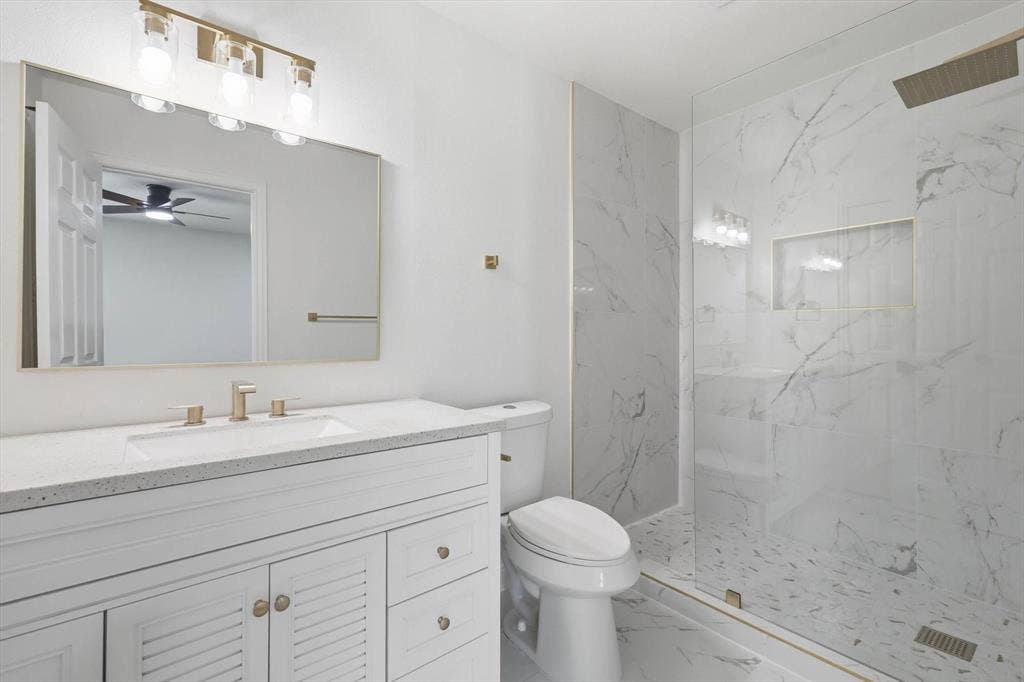 2211 Sierra Drive, Grapevine, TX 76051 Full bath with vanity, a marble finish shower, marble finish floors, and a ceiling fan