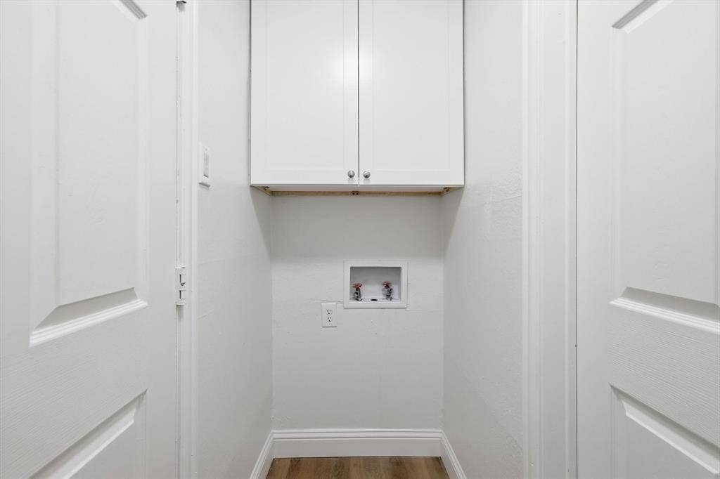 2211 Sierra Drive, Grapevine, TX 76051 Laundry room with wood finished floors, cabinet space, and washer hookup