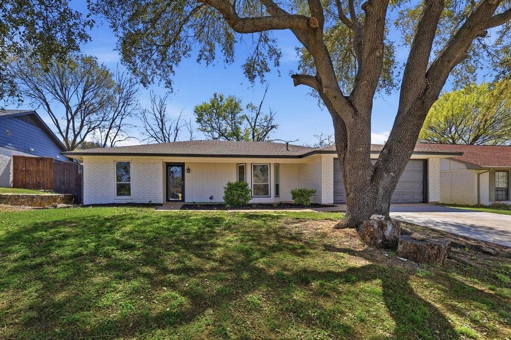 2211 Sierra Drive, Grapevine, TX 76051 Ranch-style house featuring brick siding, an attached garage, concrete driveway, and covered porch