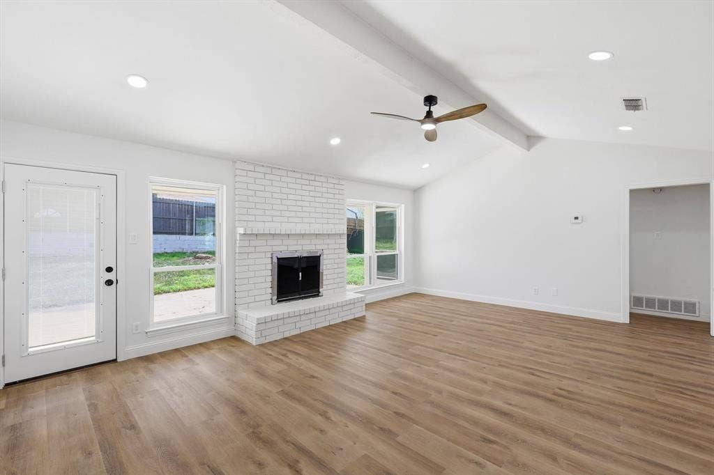2211 Sierra Drive, Grapevine, TX 76051 Unfurnished living room featuring recessed lighting, a ceiling fan, a fireplace, light wood-style floors, and beamed ceiling