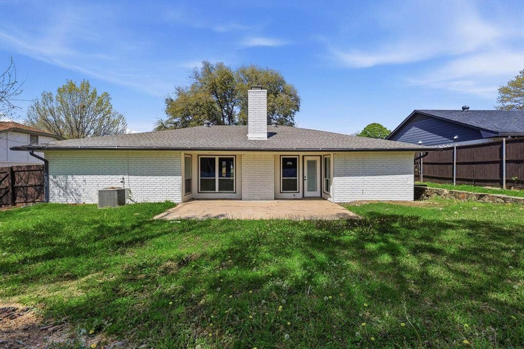 2211 Sierra Drive, Grapevine, TX 76051 Rear view of property featuring a fenced backyard, a chimney, a patio, and brick siding