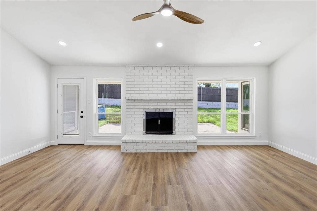 2211 Sierra Drive, Grapevine, TX 76051 Unfurnished living room with ceiling fan, light wood-style floors, a fireplace, and recessed lighting