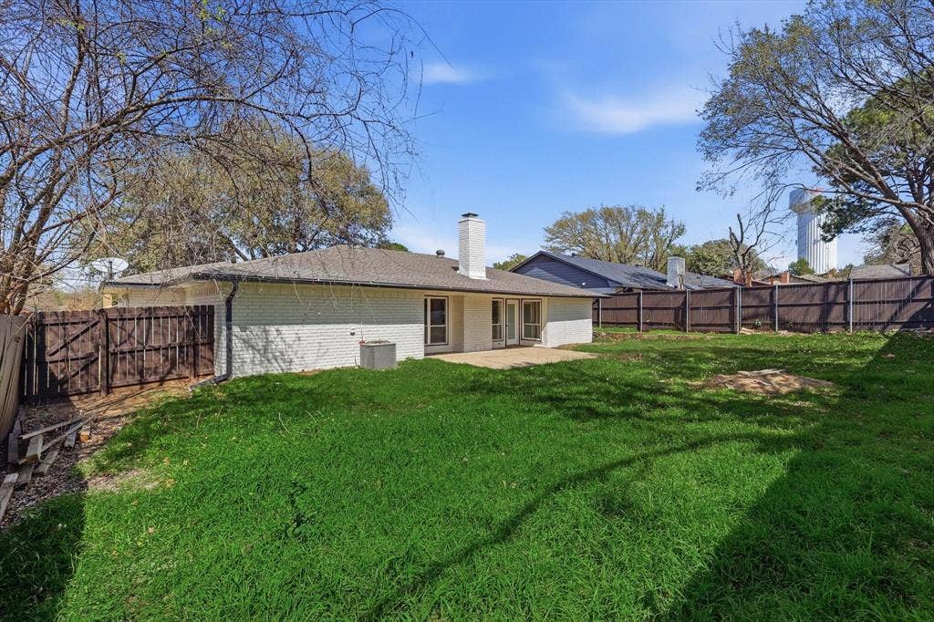 2211 Sierra Drive, Grapevine, TX 76051 Rear view of property with a patio area, brick siding, a fenced backyard, and a chimney
