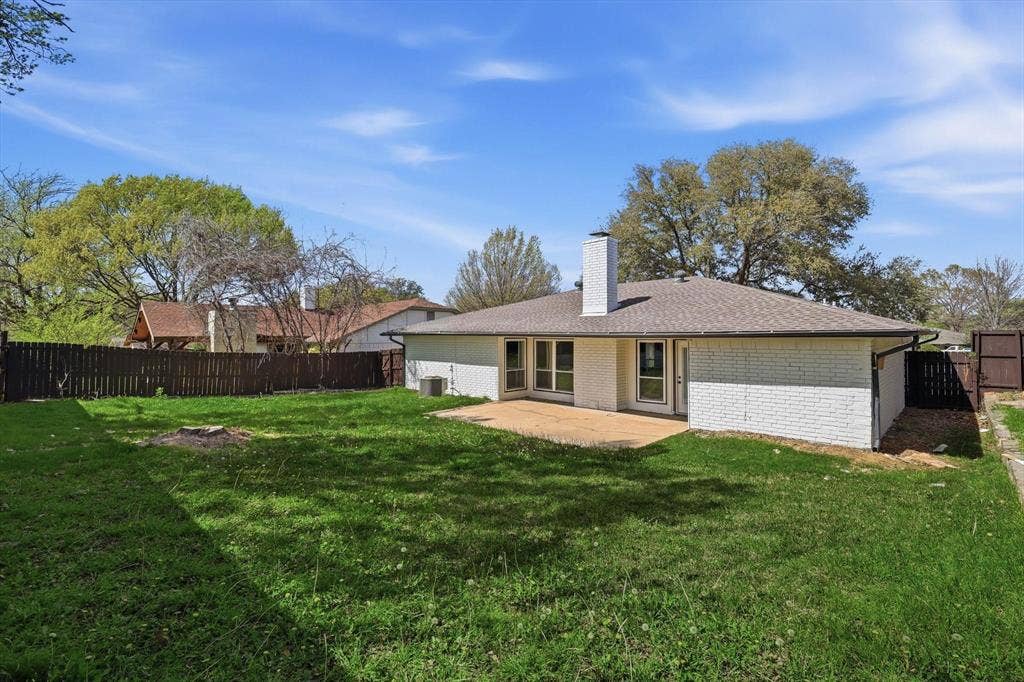 2211 Sierra Drive, Grapevine, TX 76051 Back of house featuring brick siding, a patio, a fenced backyard, and a chimney