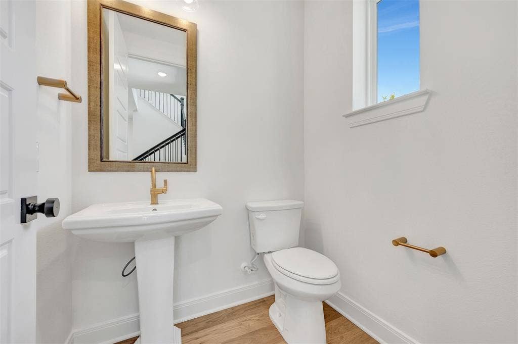 4721 Vizsla Lane, McKinney, TX 75071 Pedestal sink with brass-finish faucet and hardware