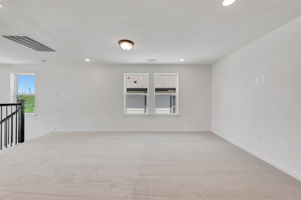 4721 Vizsla Lane, McKinney, TX 75071 Spacious room featuring light-colored carpeting, white painted walls, and multiple windows