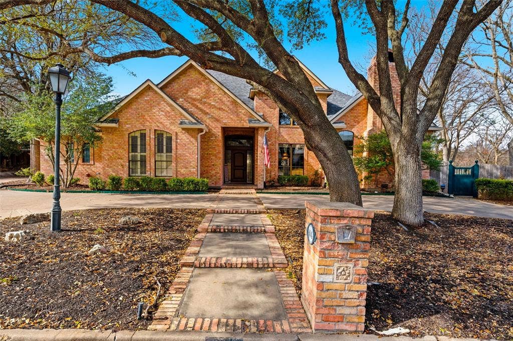 Traditional-style home with brick siding