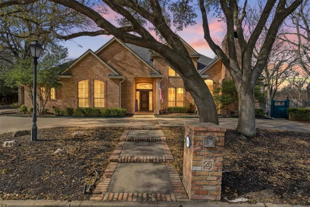 Traditional home featuring brick siding