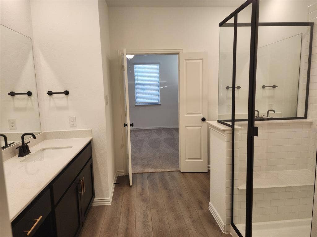 627 Redwood Way, Mansfield, TX 76063 Full bath featuring vanity, a stall shower, and dark wood-type flooring