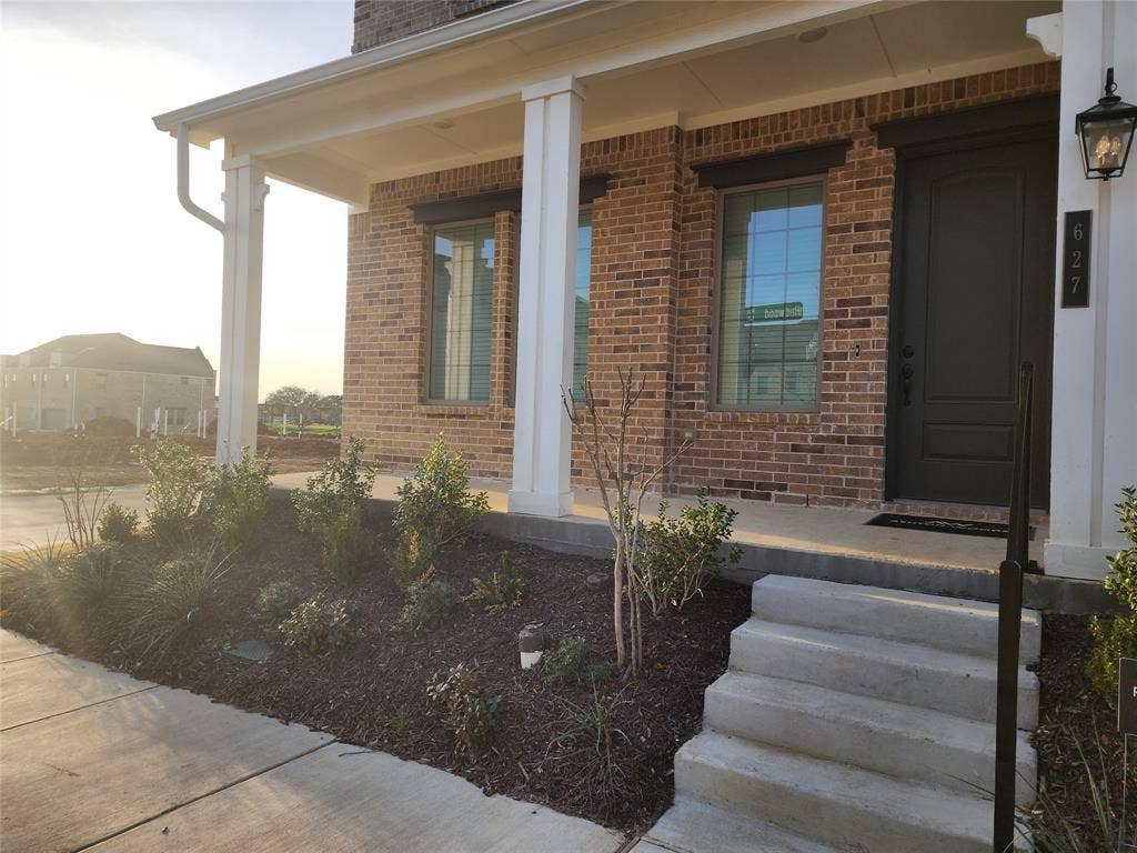 627 Redwood Way, Mansfield, TX 76063 View of side of home with a porch and brick siding