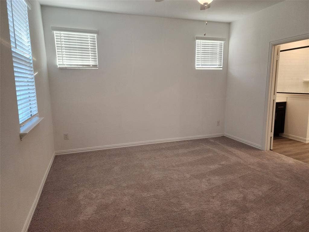 627 Redwood Way, Mansfield, TX 76063 Unfurnished bedroom featuring dark carpet and ceiling fan