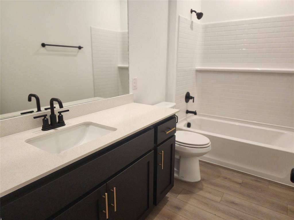 627 Redwood Way, Mansfield, TX 76063 Bathroom featuring vanity, dark wood-style flooring, and tub / shower combination