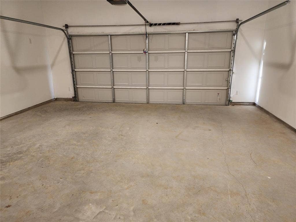 627 Redwood Way, Mansfield, TX 76063 Garage featuring baseboards