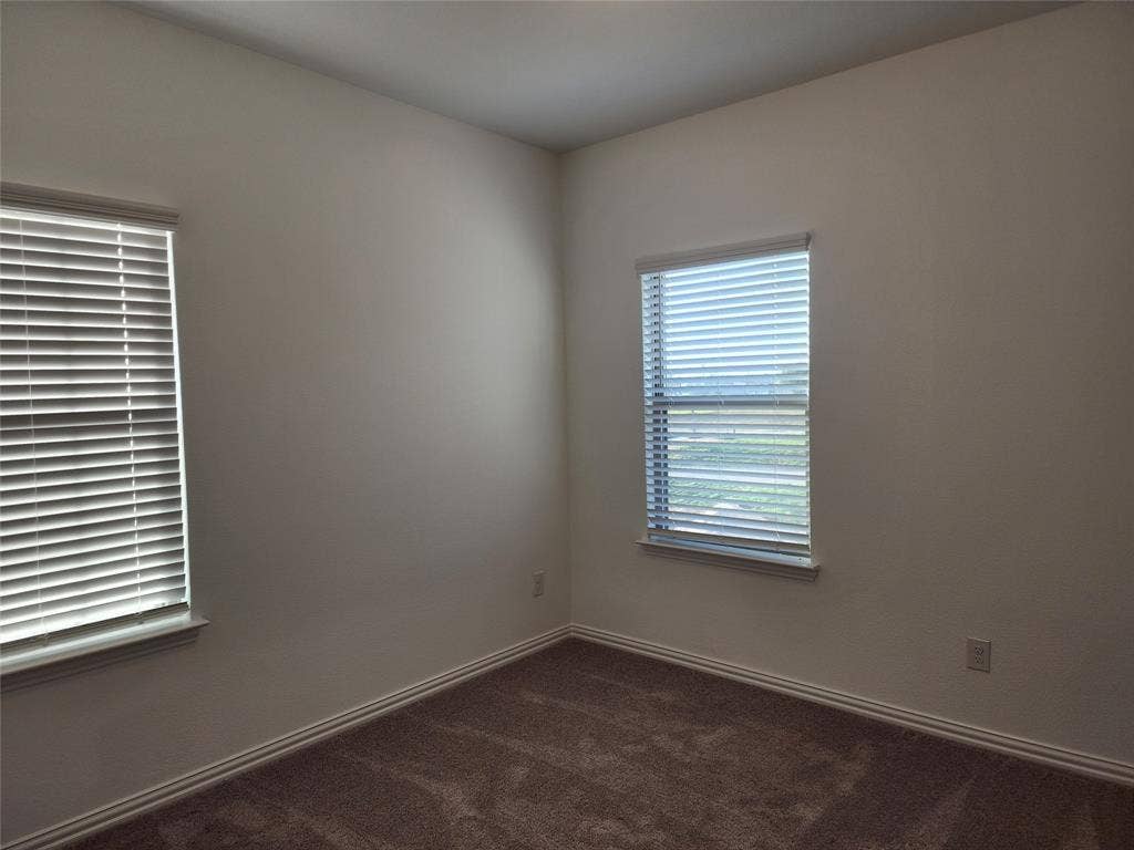 627 Redwood Way, Mansfield, TX 76063 Spare room with dark carpet and baseboards
