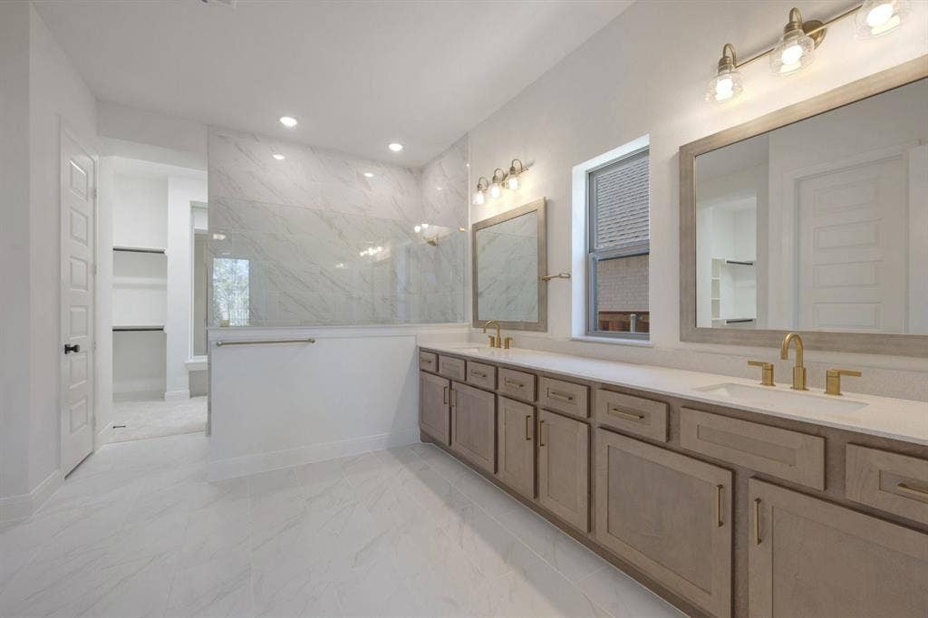 3283 Jersey Drive, Midlothian, TX 76065 Spacious bathroom featuring a dual vanity with light wood-finish cabinetry and gold-tone hardware, white countertops, and dual mirrors