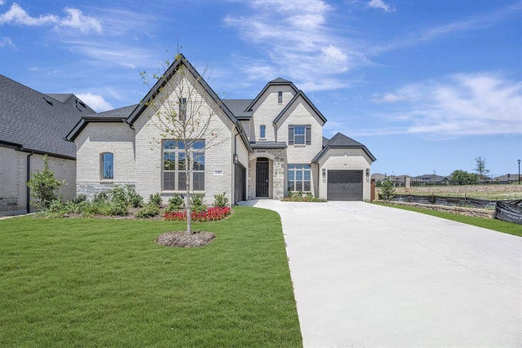 3283 Jersey Drive, Midlothian, TX 76065 Stately two-story residence featuring a light-colored brick and stone façade with dark trim accents