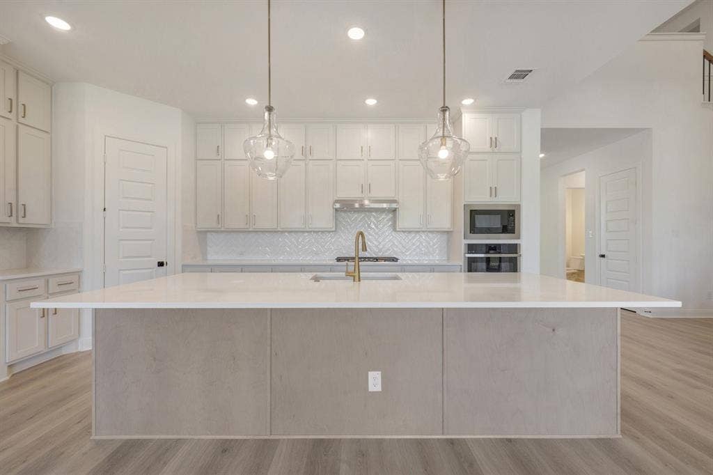 3283 Jersey Drive, Midlothian, TX 76065 Spacious kitchen island with a light-toned countertop