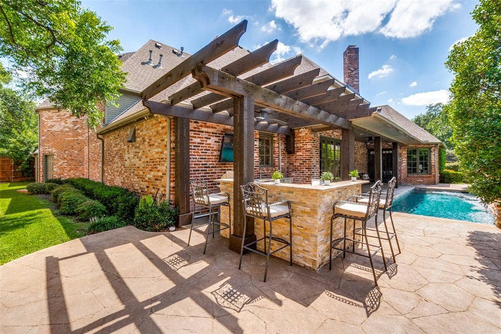 6615 Meadow Road, Dallas, TX 75230 Entertaining has never been more fun than grilling poolside while catching the game. Relax by the pool and enjoy the sounds of the three pool fountains. The heated pool can be enjoyed year round and accessed directly from the 1st floor primary suite.