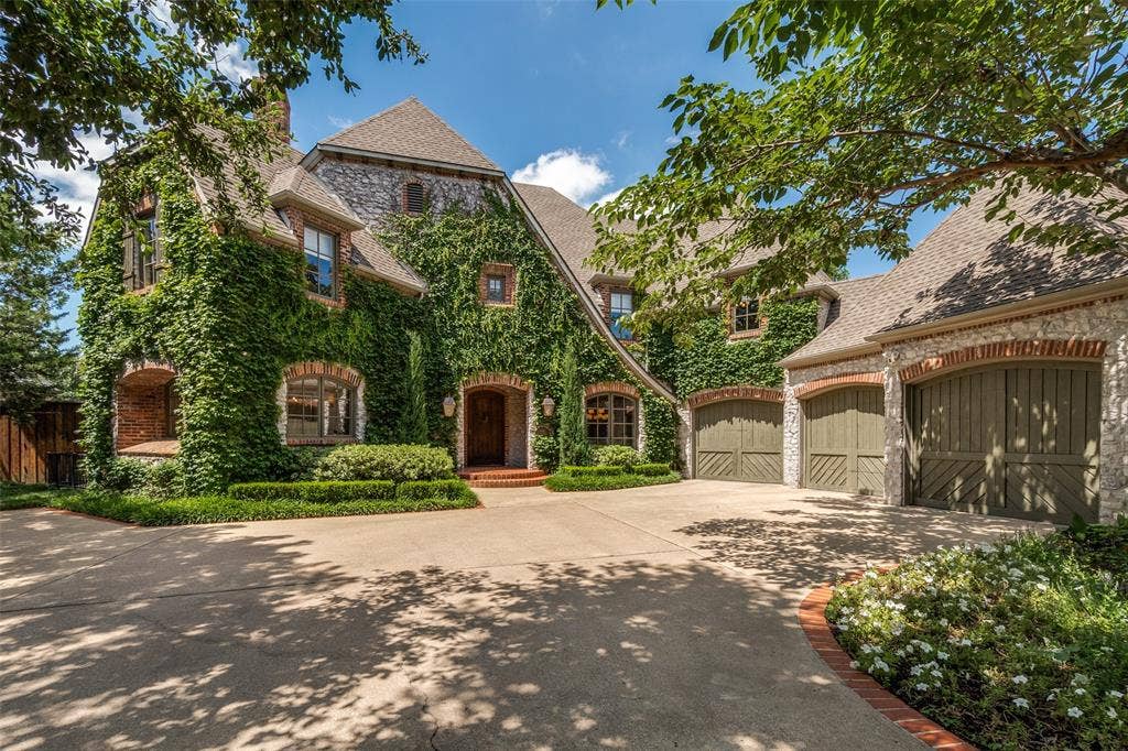 6615 Meadow Road, Dallas, TX 75230 Manicured ivy exterior accented by copper lanterns and brick and stone exteriorior. Mature trees envelope the front driveway with ample parking for guests. New windows replaced in many rooms. Three car garage with extra storage space.
