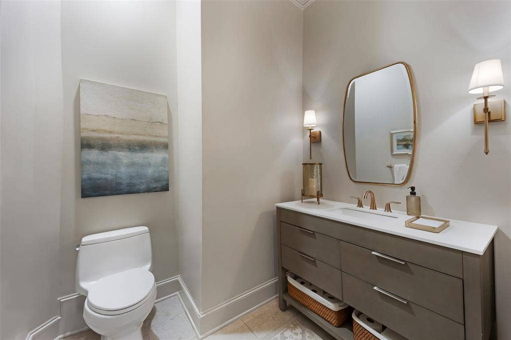 6615 Meadow Road, Dallas, TX 75230 Updated 1st floor guest powder bath is situated in a private hall in between the kitchen, dining and family room.