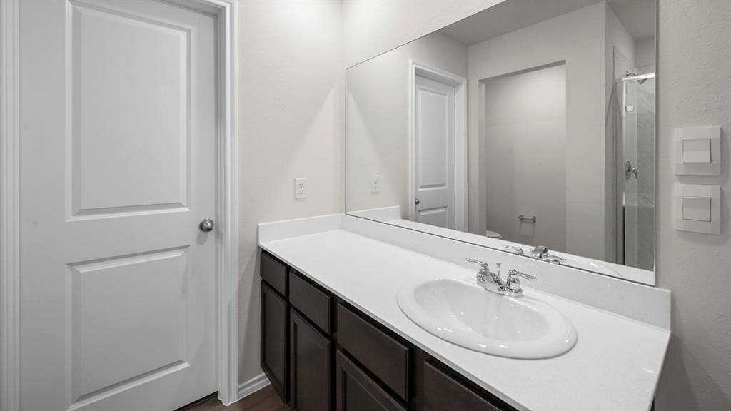 Bathroom with vanity and a stall shower