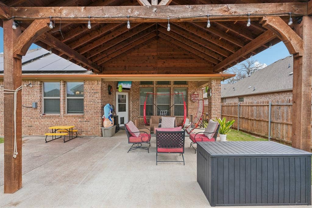 Covered patio with outdoor seating, ideal for relaxing and entertaining.