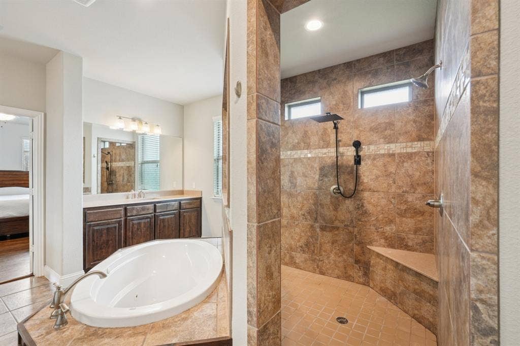 Primary bathroom featuring a walk-through shower with dual shower heads.